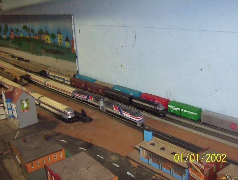 Photo of a long look at my layout looking at a pair of pepsi cans and a ab set of b&o f7'