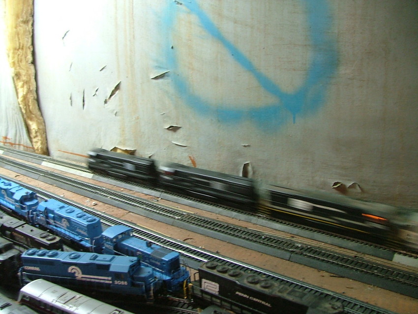 Photo of three penn central u28c's pulling a big 45 car train on my layout